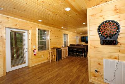 Timber Tree Lodge game room with dart board