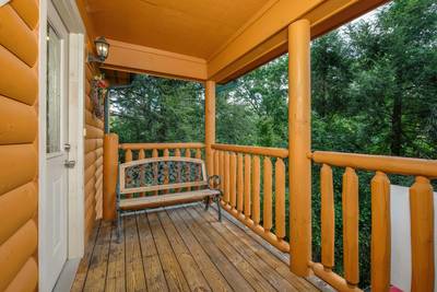 Timber Tree Lodge main level covered back deck with bench