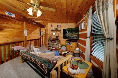 Mountain Magic upper level loft area with 65-inch TV with surround sound