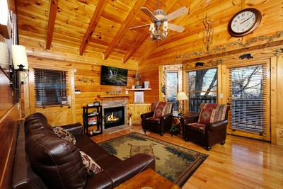 River Falls living room with stone encased gas log fireplace