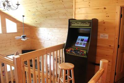 Lighthouse Harbor upper level open loft with stand-up arcade machine