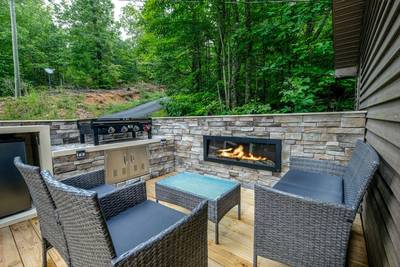 The Road Less Traveled front deck with electric fireplace