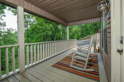 The Road Less Traveled covered front deck with rocking chairs