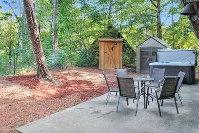 Fuzzy Bear fenced in back yard with table and chairs