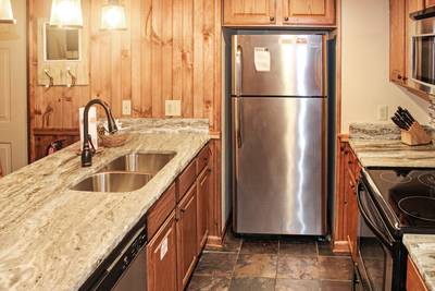 Mountain Side fully furnished kitchen with granite countertops and stainless steel appliances