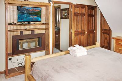 Mountain Side upper level bedroom 2 with year-round electric fireplace