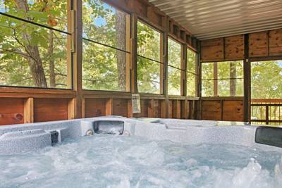 Mountain Side lower level screened in back deck with hot tub