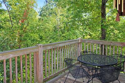 Mountain Side main level wraparound deck with metal chairs