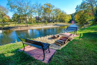 River Livin outdoor fire pit and benches located next to the Little Pigeon River