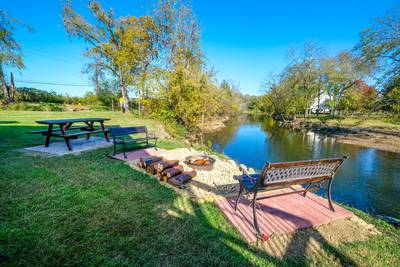River Livin outdoor fire pit and benches located next to the Little Pigeon River