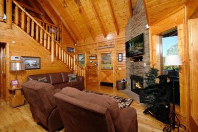 River Livin living room with stone encased gas fireplace
