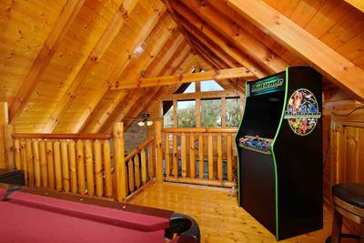 River Livin upper level loft game room with arcade system