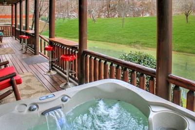 Creekside Lodge lower level covered deck with hot tub