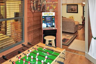 Bear Run sunroom with foosball table and stand up arcade machine