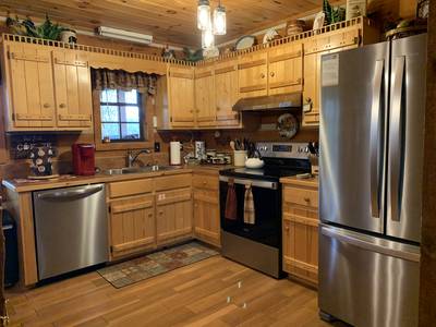 Mountain Magic fully furnished kitchen with stainless steel appliances 