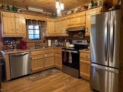 Mountain Magic fully furnished kitchen with stainless steel appliances