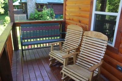River Haven covered back deck with wooden gliders and bench
