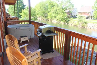 River Haven covered back deck with hot tub