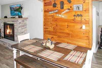 Rustic Acres dining area and seasonal gas log fireplace