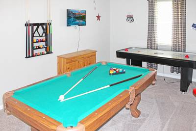 Rustic Acres game room with pool table and air hockey table