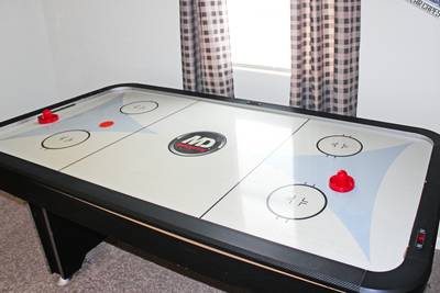 Rustic Acres game room with air hockey table