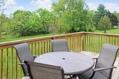 Rustic Acres back deck with table and chairs