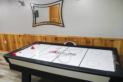 Striking Waters air hockey table in lower level game room