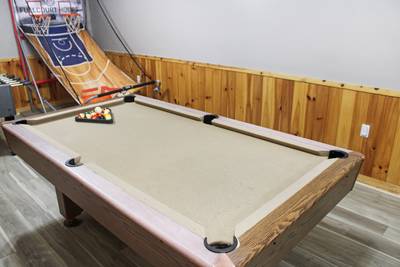 Striking Waters pool table in lower level game room