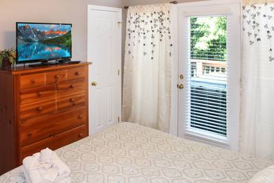 Striking Waters main level bedroom two with 25-inch flat screen tv