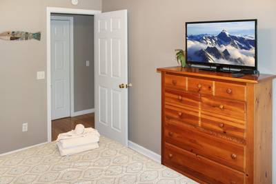 Striking Waters main level bedroom two with 25-inch flat screen TV