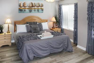 Striking Waters main level bedroom one with king size bed