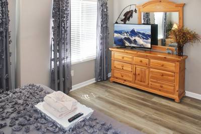 Striking Waters main level bedroom one with 50-inch flat screen tv