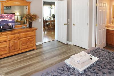 Striking Waters main level bedroom one with 50-inch flat screen TV