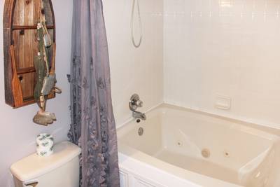Striking Waters main level bathroom one with jetted tub/shower combo