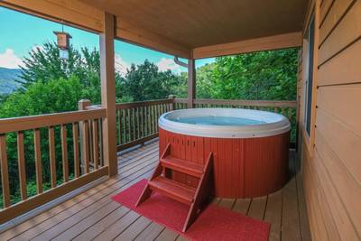 Bearfootin covered back deck with hot tub