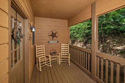 Bearfootin covered back deck with rocking chairs