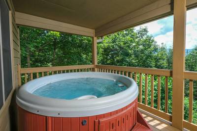 Nestled Inn covered back deck with hot tub