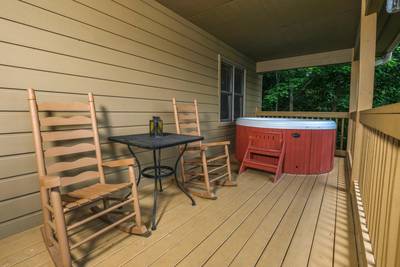 Nestled Inn covered back deck with rocking chairs