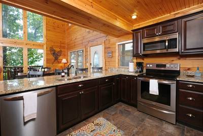 Angels View fully furnished kitchen with granite countertops and stainless steel appliances