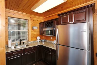 Angels View lower level kitchenette with granite countertops and stainless steel appliances