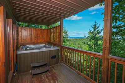 Angels View lower level covered back deck with hot tub and view