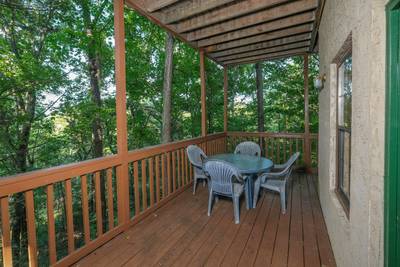Grandpas Getaway lower level covered deck with table and chairs