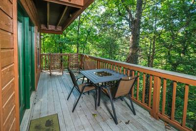 Grandpas Getaway main level wraparound deck with table and chairs