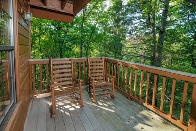 Grandpas Getaway main level wraparound deck with rocking chairs