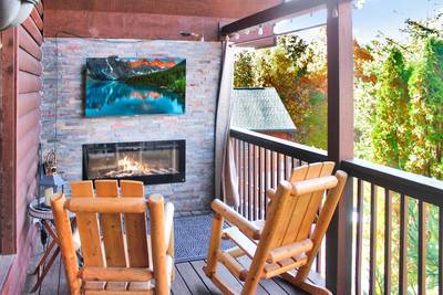 My Pigeon Forge Cabin main level covered back deck with 50-inch TV and year-round electric fireplace