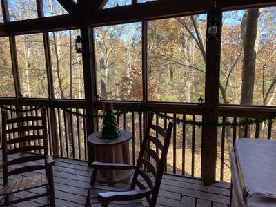 Papa's Pad screened in back deck with rocking chairs