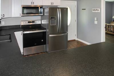 Wolff Lodge fully furnished kitchen with granite countertops and stainless steel appliances