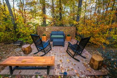 Bearfoots Cozy Cabin lower level yard deck with wicker furniture