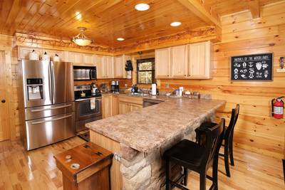 Bearfoots Cozy Cabin fully furnished kitchen with stainless steel appliances and granite countertops