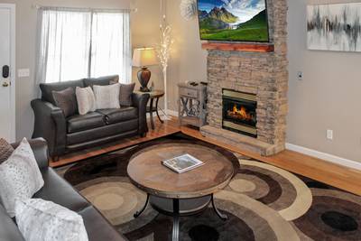 Alluring River living room with gas fireplace and 55-inch TV